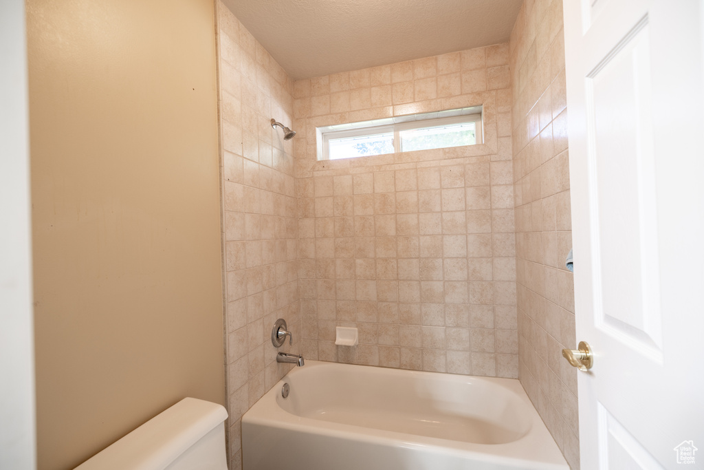 Bathroom with toilet and shower / bath combination