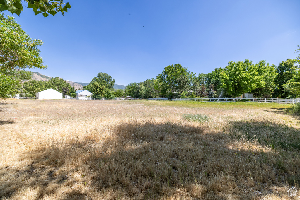 View of yard featuring a rural view and a mountain view