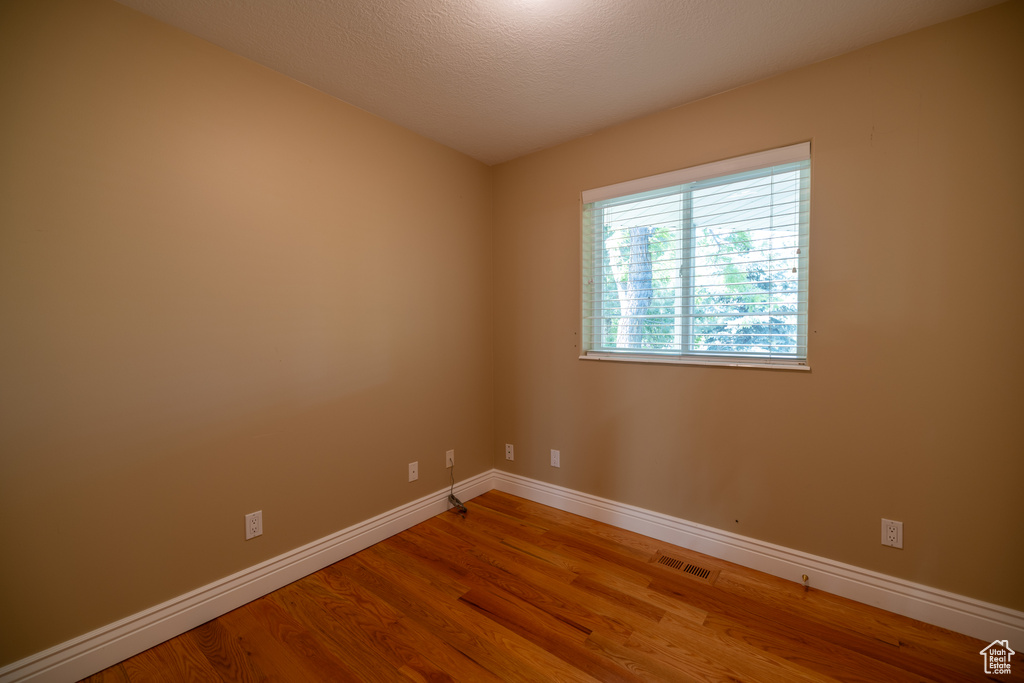 Empty room with wood finished floors and baseboards