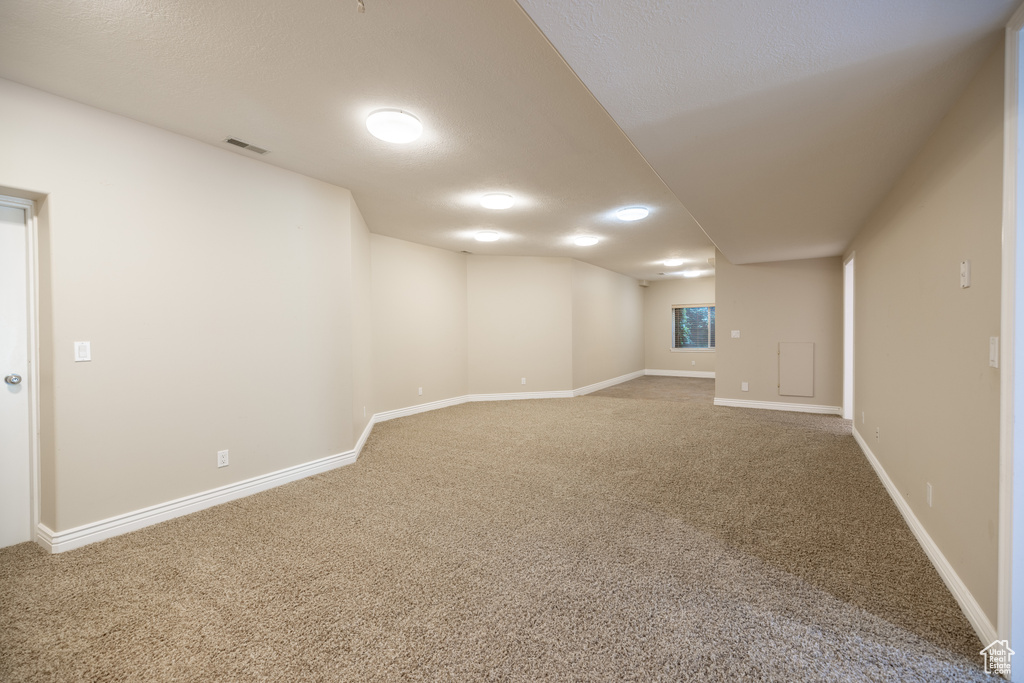 Finished below grade area featuring carpet floors and baseboards