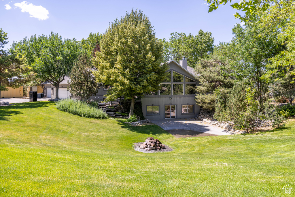 Back of property with a yard and a chimney