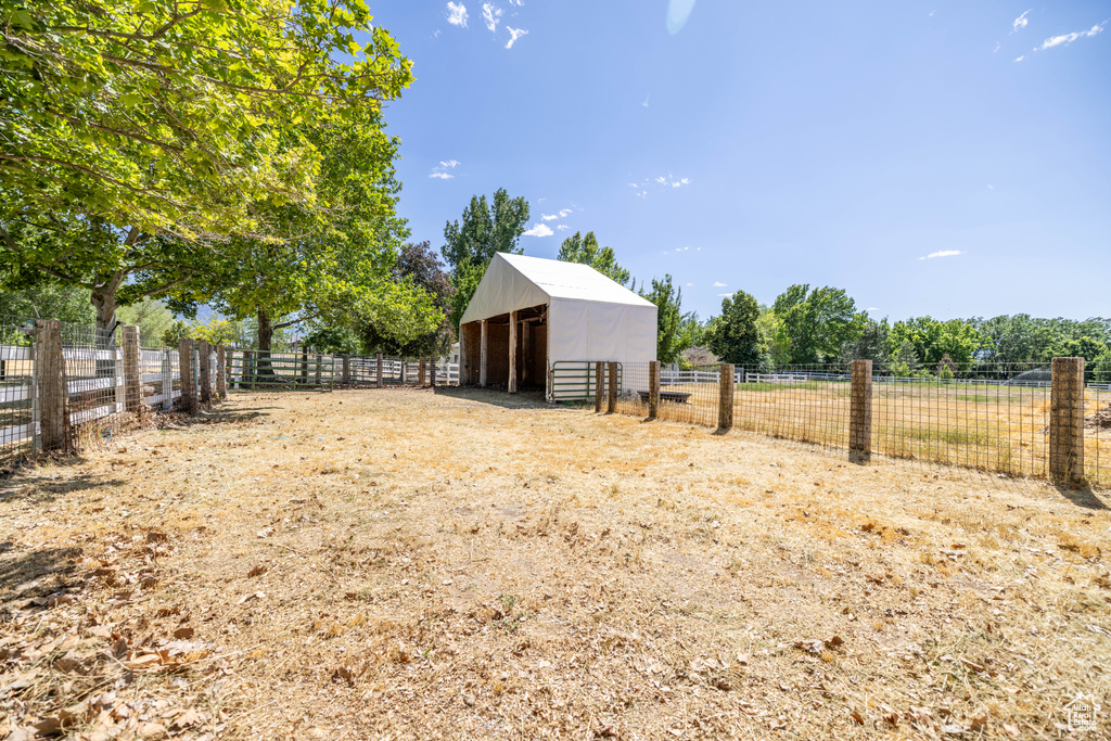 View of yard with an exterior structure, an outbuilding, and a view of rural / pastoral area