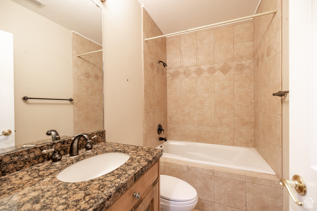 Full bath with vanity and tiled shower / bath