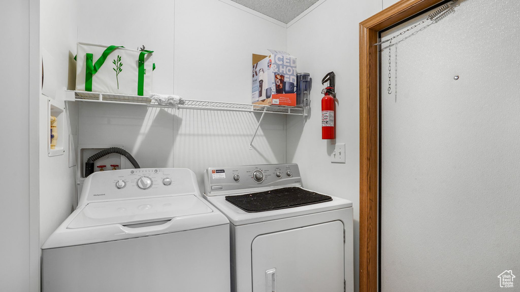 Laundry room with washing machine and dryer and crown molding