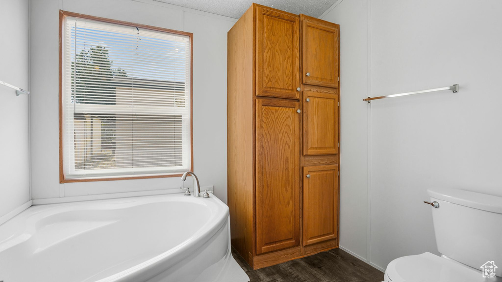 Full bathroom with a bath and wood finished floors