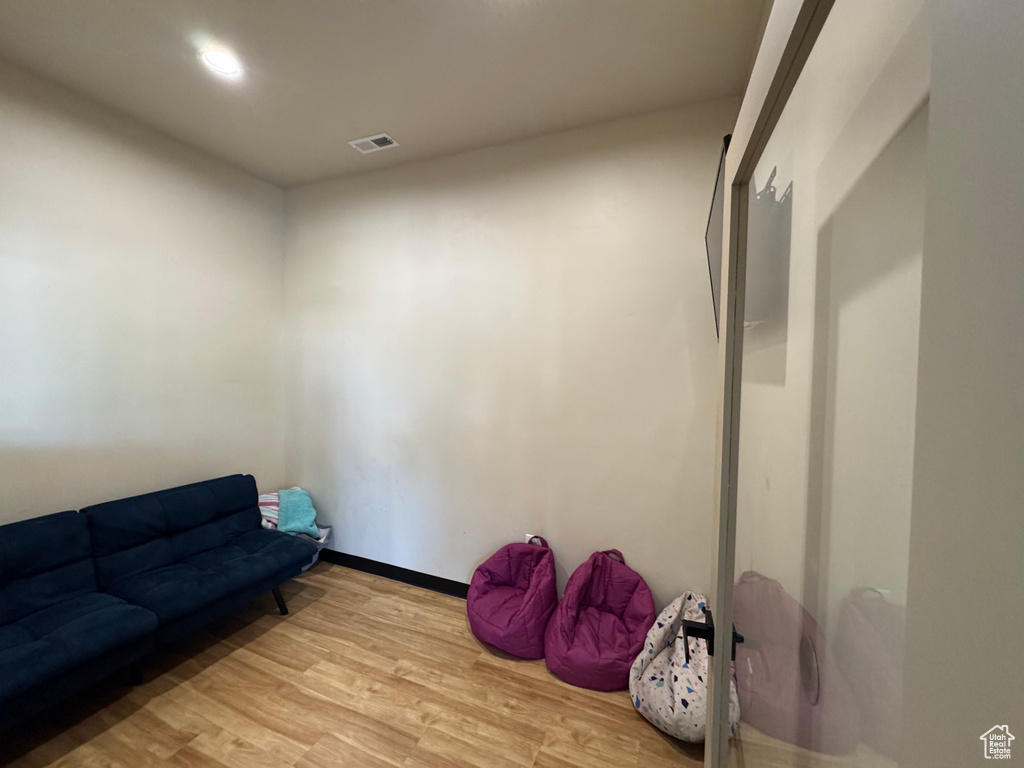 Sitting room featuring light wood-style flooring and recessed lighting