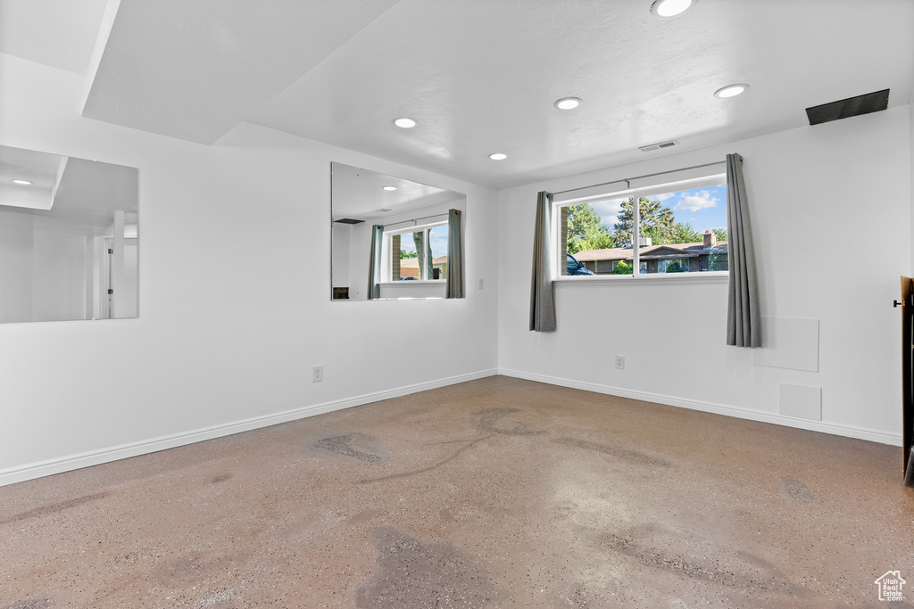 Unfurnished room featuring recessed lighting and speckled floor