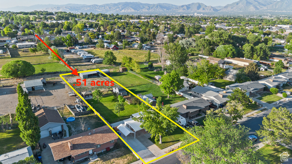 Aerial view of residential area featuring mountains and property boundaries highlighted