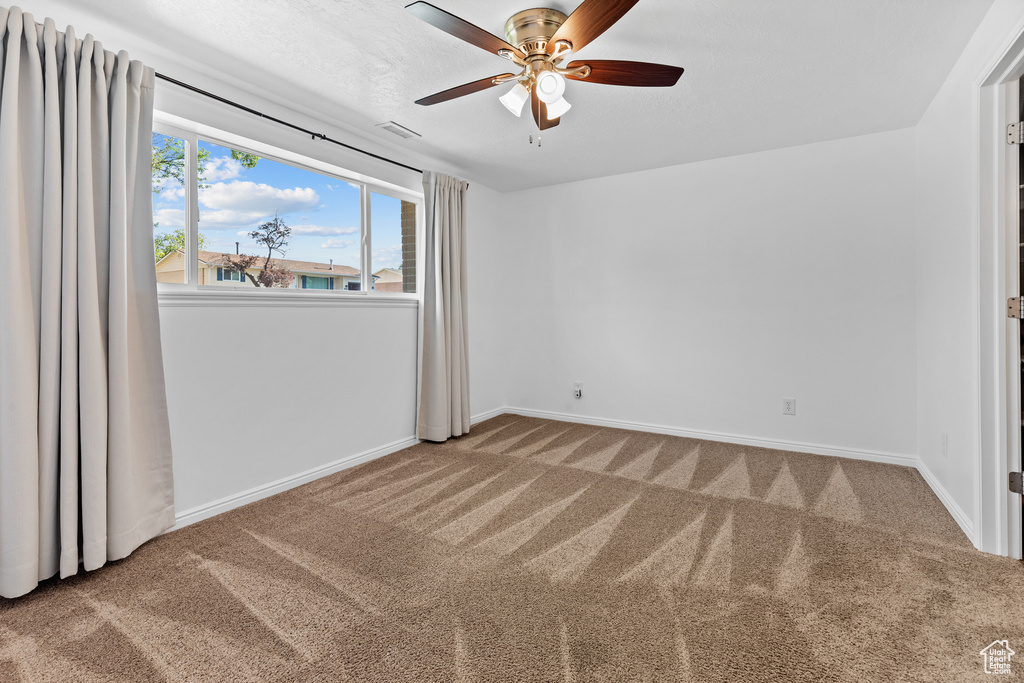 Unfurnished bedroom with carpet and a ceiling fan