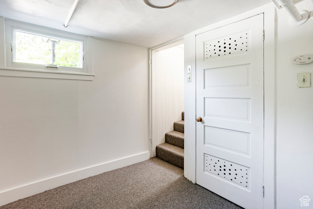 Basement featuring carpet flooring and stairway