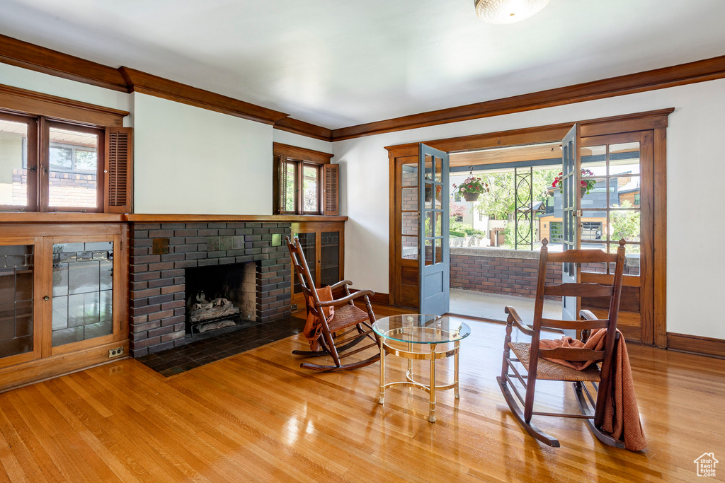 Living area with wood finished floors and a brick fireplace