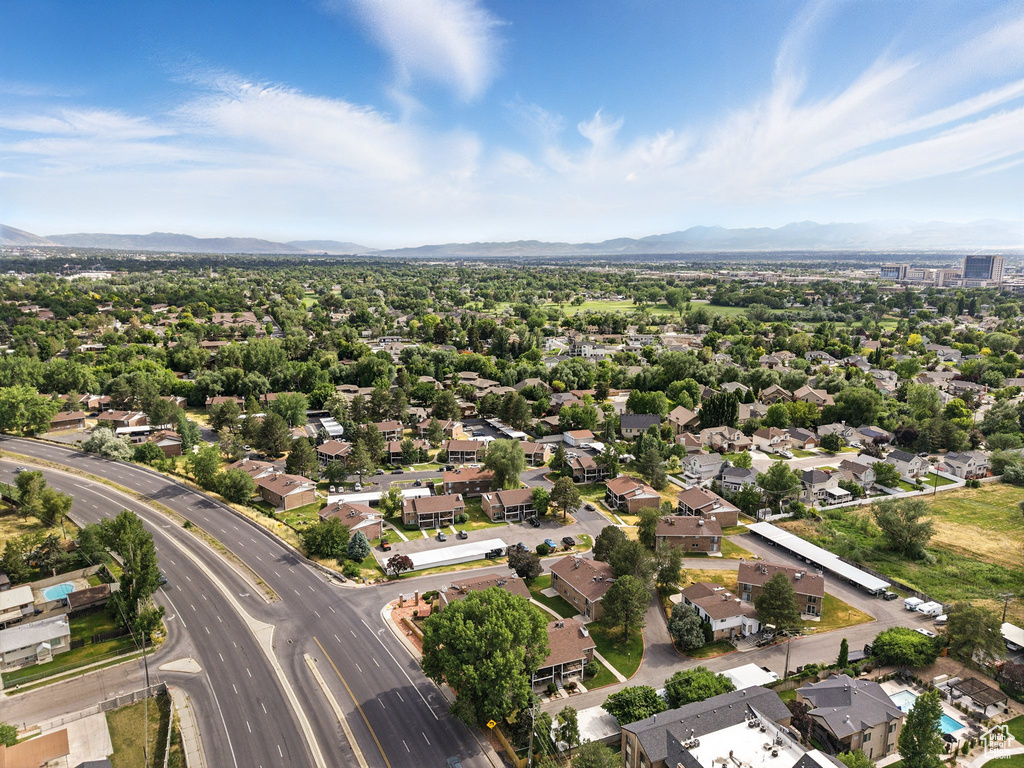 Aerial overview of property's location with mountains and nearby suburban area