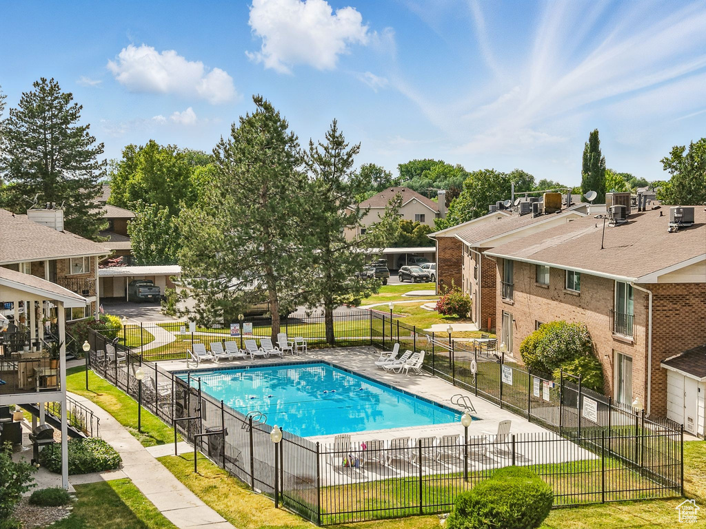 Community pool with a residential view