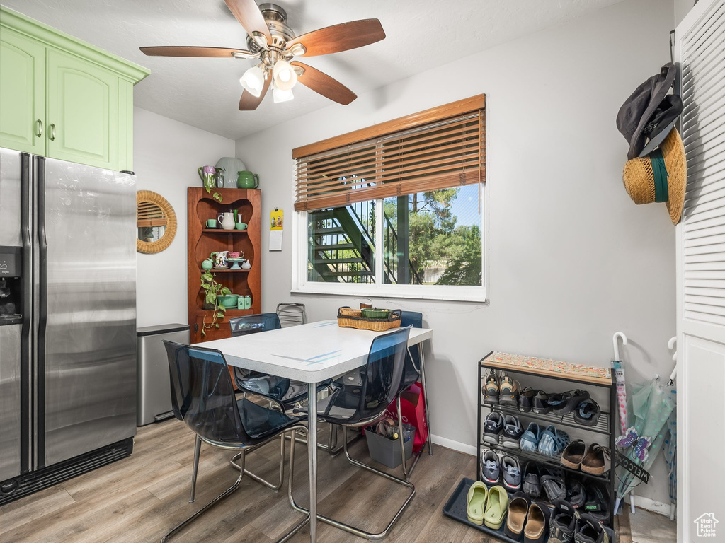 Dining area with light wood-type flooring and a ceiling fan