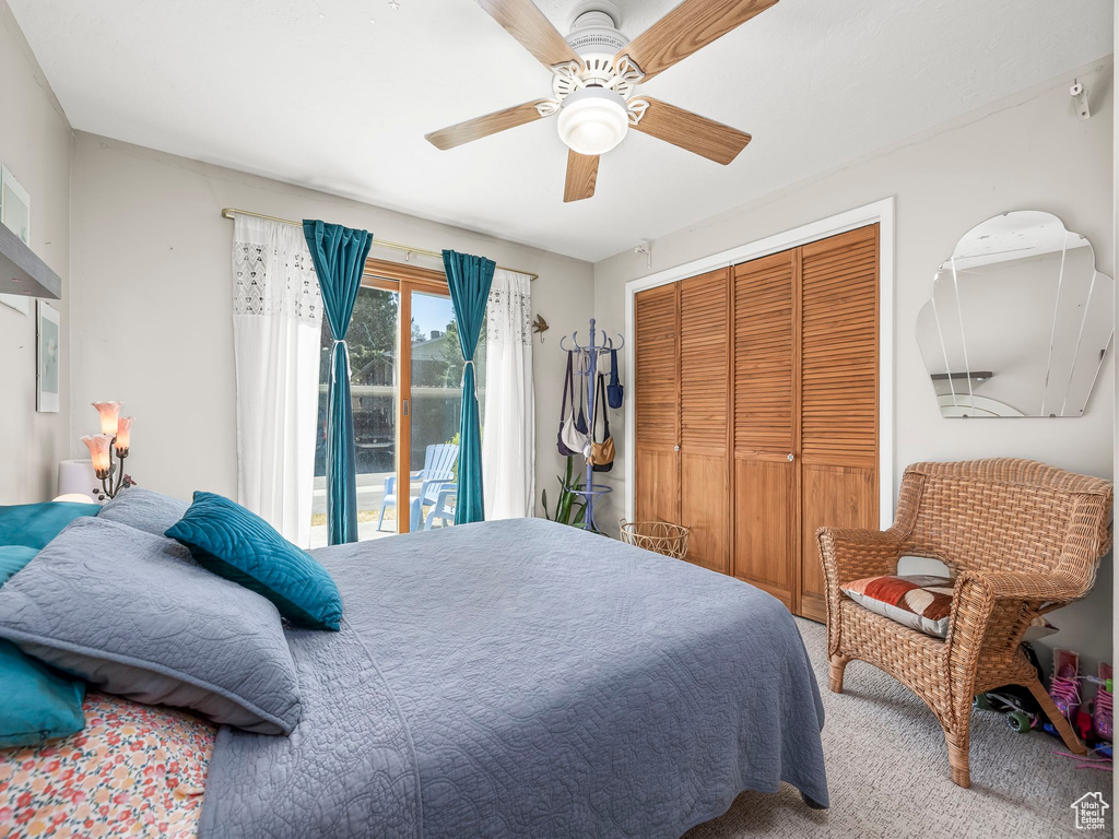 Carpeted bedroom with a closet, ceiling fan, and access to exterior