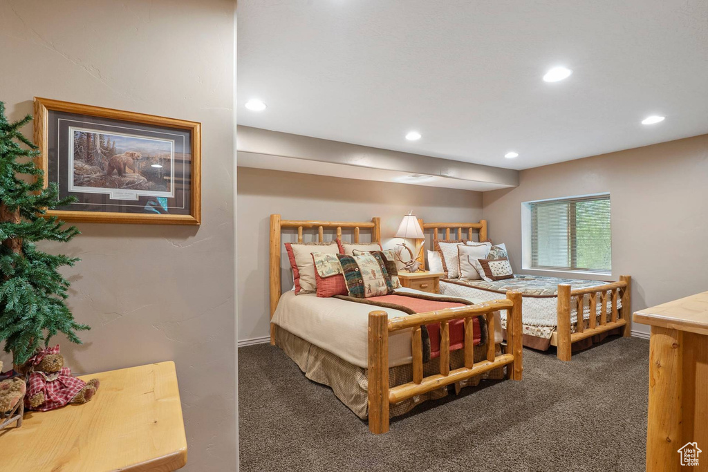 Carpeted bedroom with recessed lighting