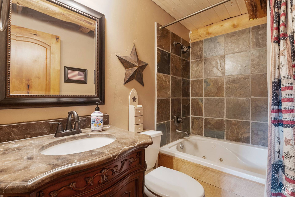 Full bathroom featuring a combined bath / shower with jetted tub and vanity