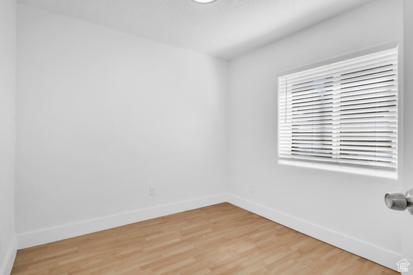 Unfurnished room featuring baseboards and light wood finished floors
