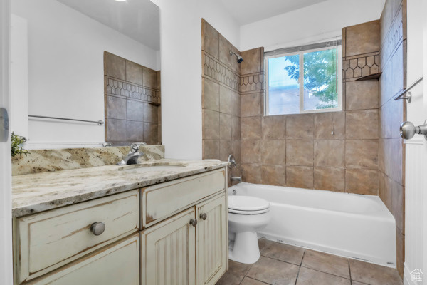 Bathroom with vanity, tile patterned flooring, and shower / bathtub combination