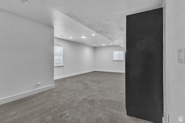 Empty room with carpet and recessed lighting