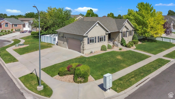 Ranch-style house with stucco siding, driveway, an attached garage, a residential view, and a shingled roof