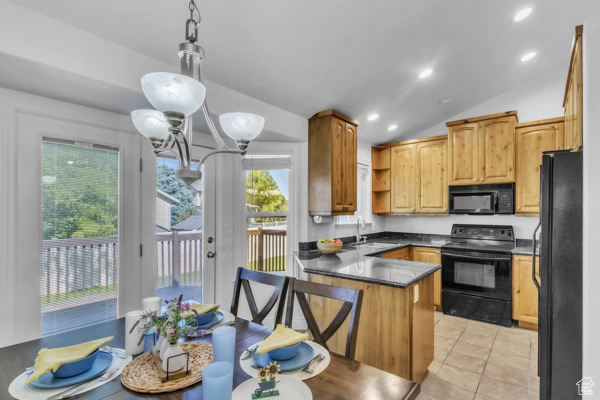Kitchen with black appliances, a peninsula, open shelves, dark countertops, and vaulted ceiling