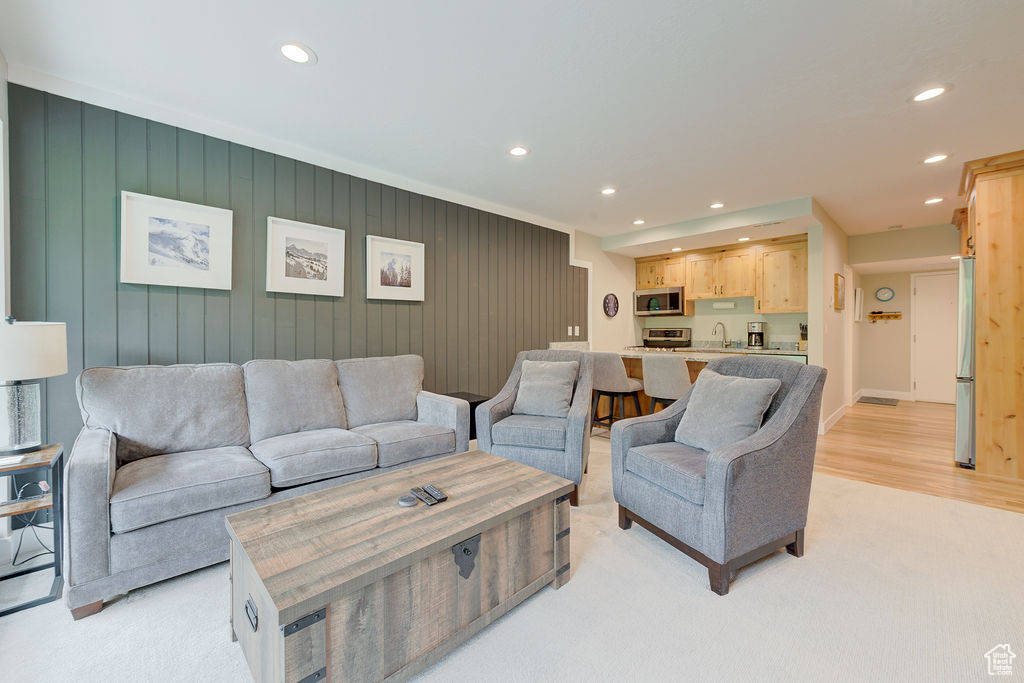 Living room featuring recessed lighting and light colored carpet