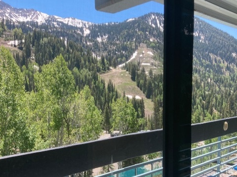 Balcony with a mountain view and a view of trees
