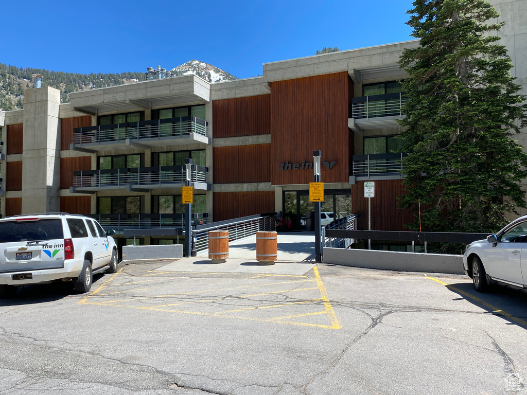 View of property with uncovered parking