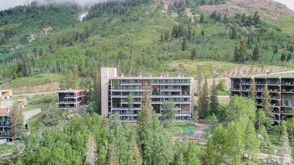 Aerial overview of property's location with apartment complex and a mountainous background