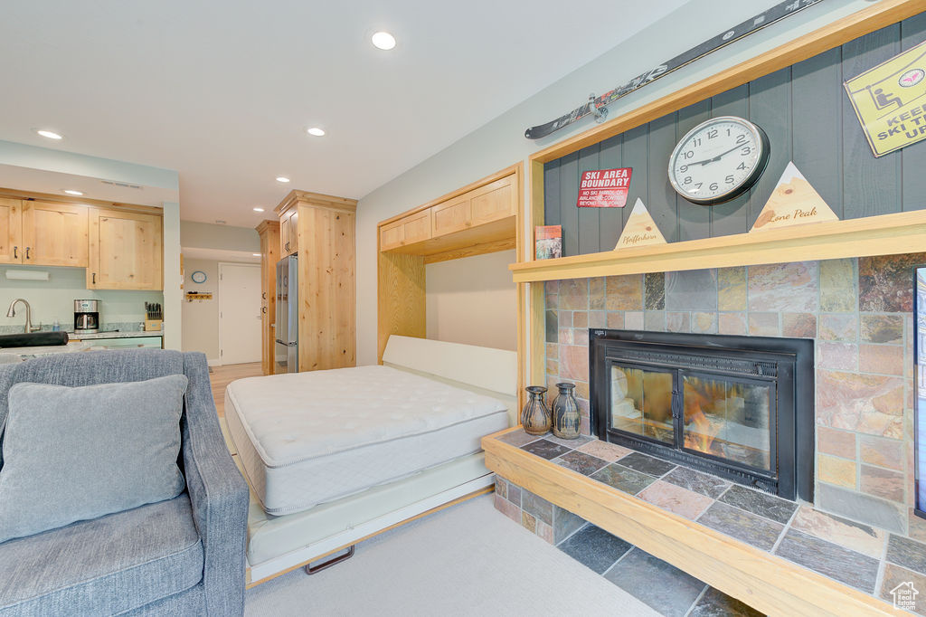 Living area featuring recessed lighting and a fireplace