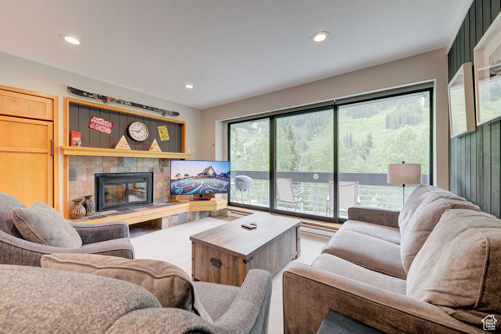 Living room with a tile fireplace and recessed lighting