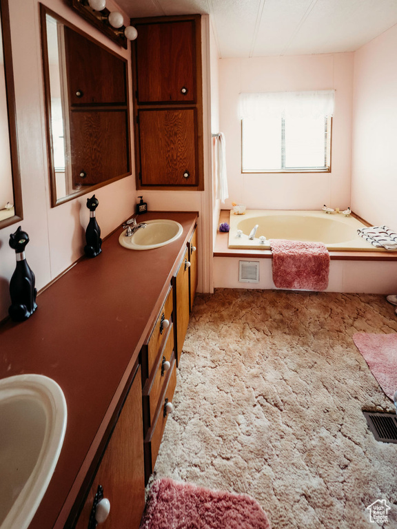 Full bathroom featuring double vanity and a bath