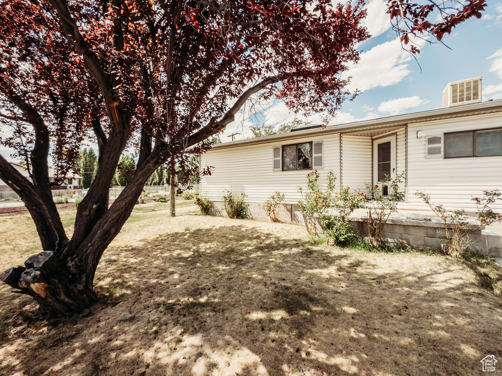 Back of property with a lawn