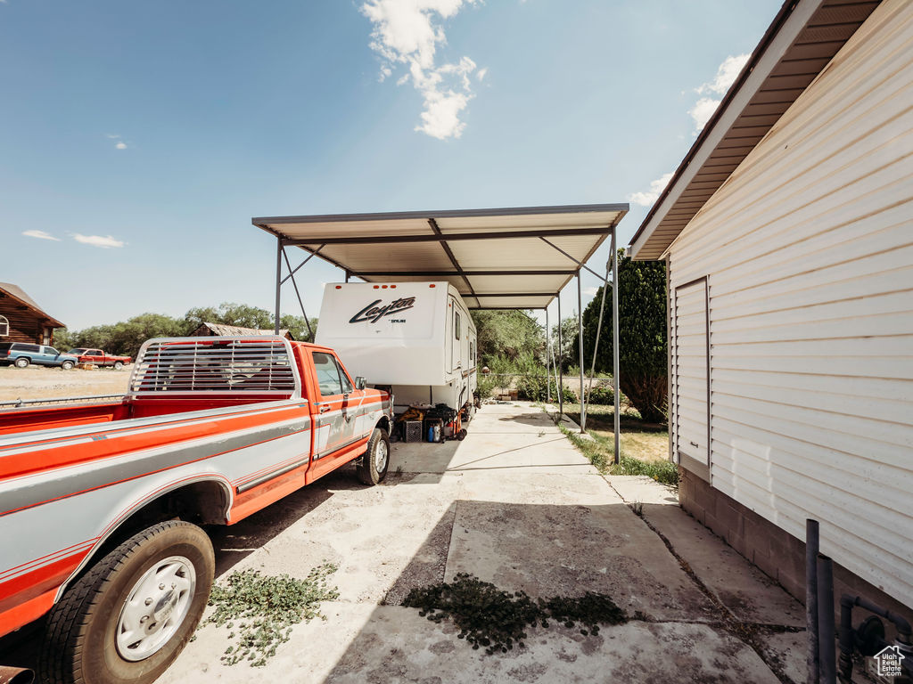 View of parking / parking lot featuring a detached carport