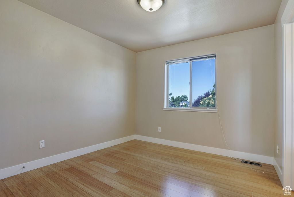Empty room featuring light wood-style flooring and baseboards