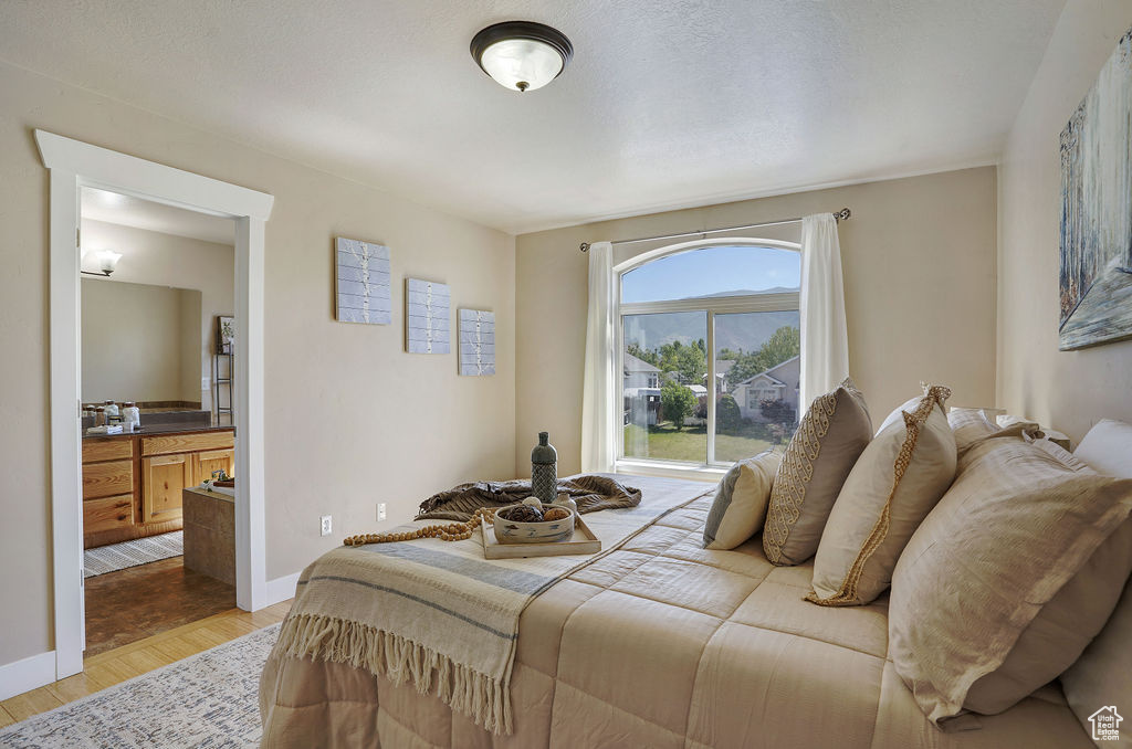 Bedroom with light wood-style floors and baseboards