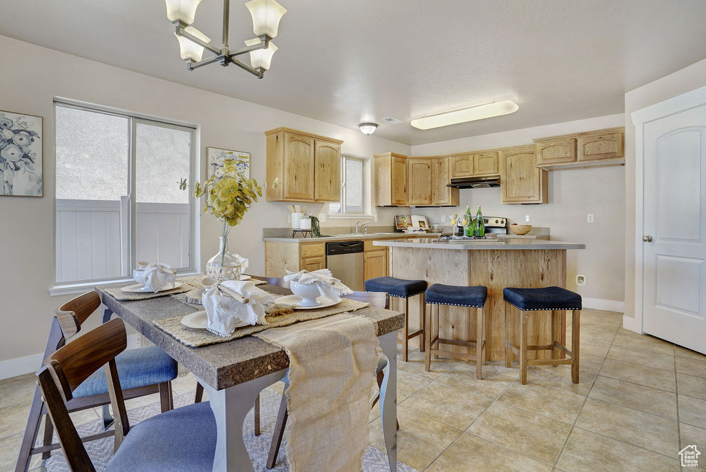 Dining area featuring a chandelier and light tile patterned floors