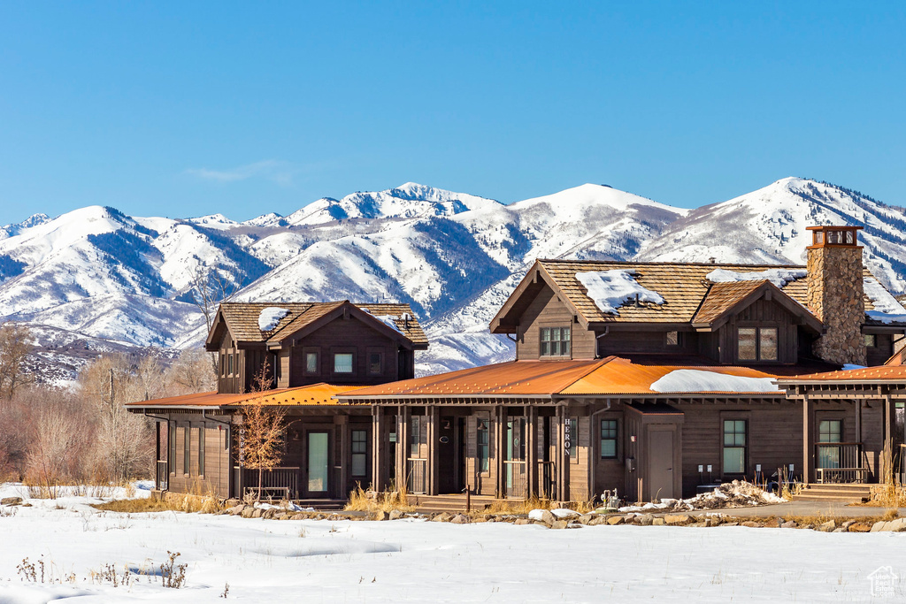 View of front of home with a mountain view and a porch