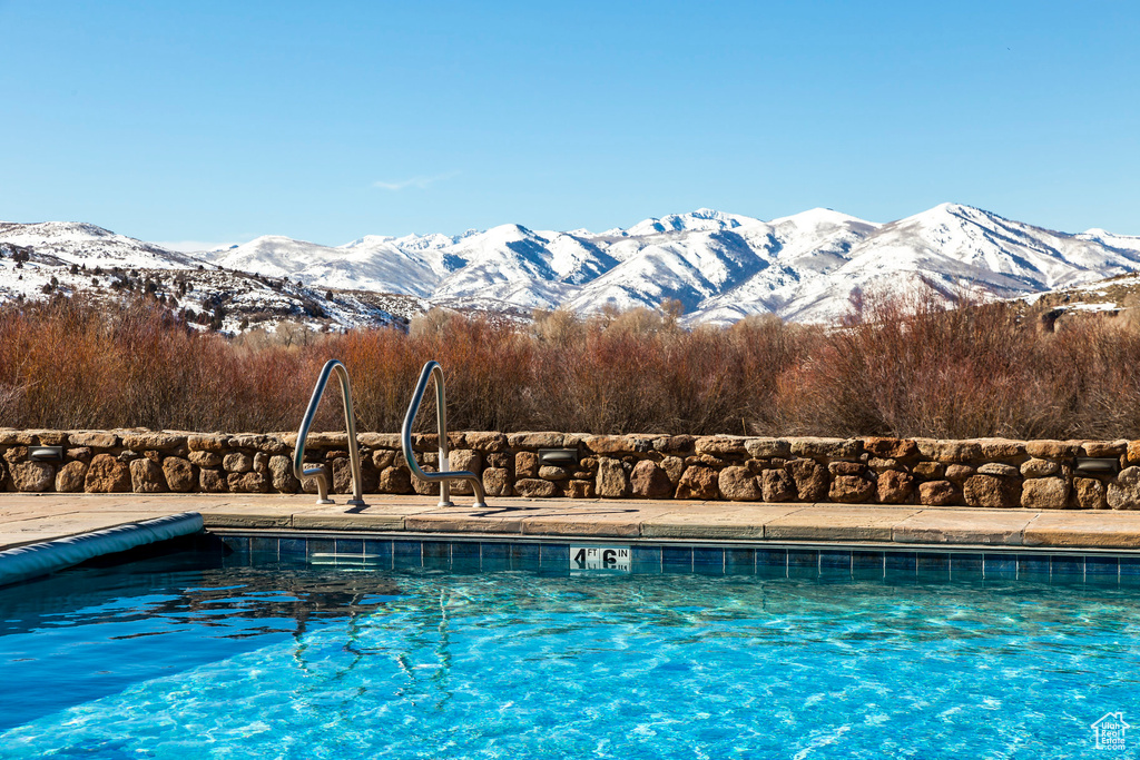 Community pool featuring a mountain view