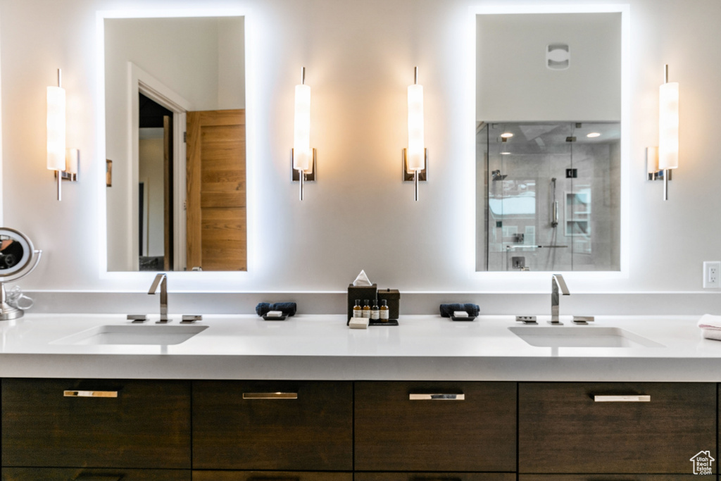 Bathroom featuring double vanity and a stall shower