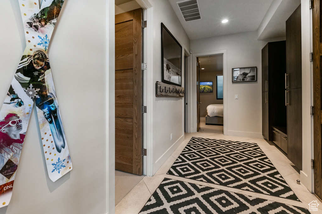 Hallway featuring light tile patterned flooring and recessed lighting