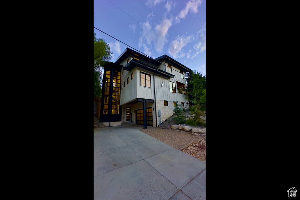View of property exterior featuring driveway and an attached garage
