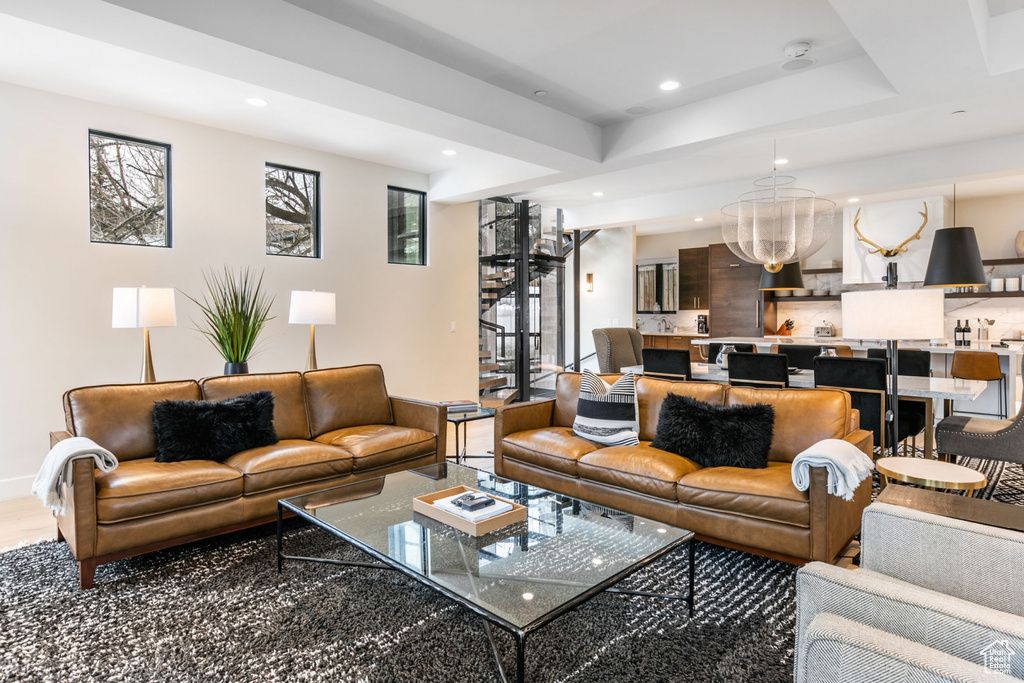 Living room featuring recessed lighting and a chandelier