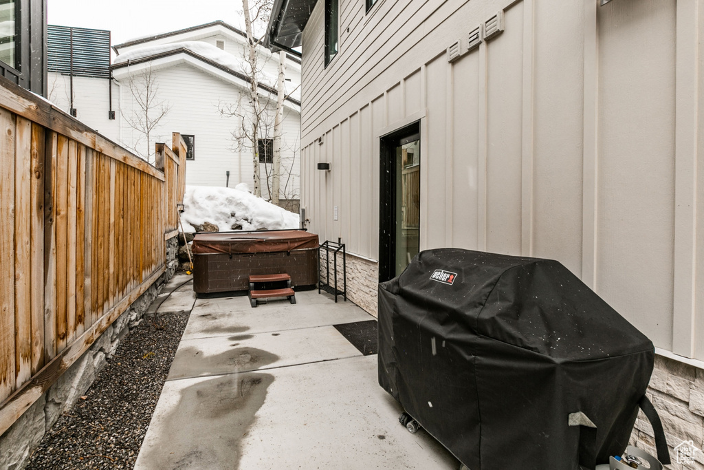 View of patio / terrace featuring a hot tub and grilling area
