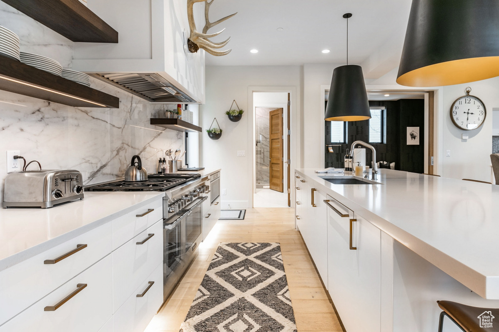 Kitchen with double oven range, open shelves, modern cabinets, tasteful backsplash, and recessed lighting