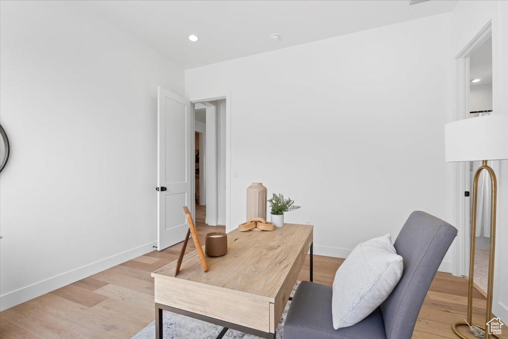Home office featuring light wood finished floors and recessed lighting