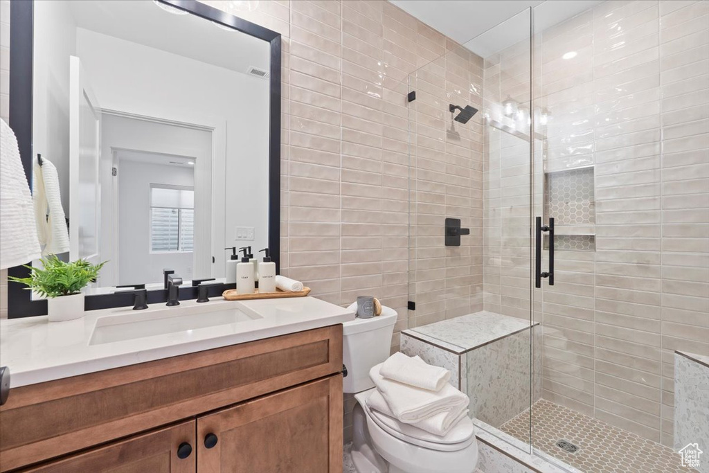 Bathroom with a stall shower and vanity
