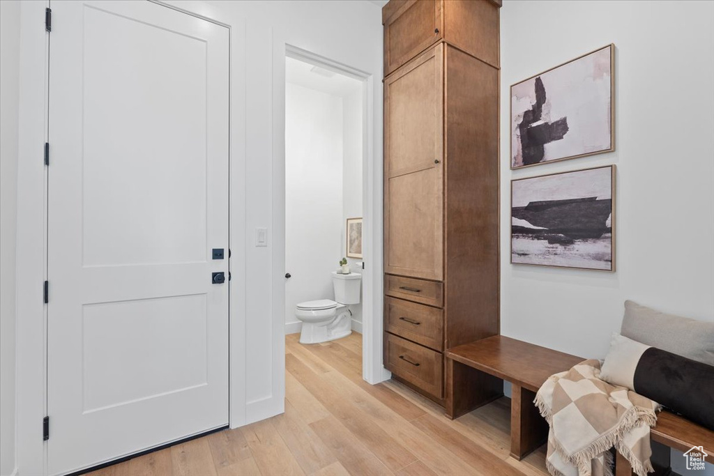 Interior space with wood finished floors and toilet