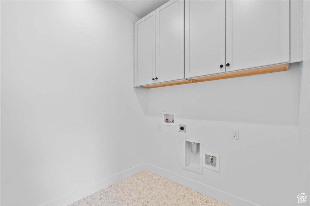Laundry area featuring cabinet space, hookup for an electric dryer, and hookup for a washing machine
